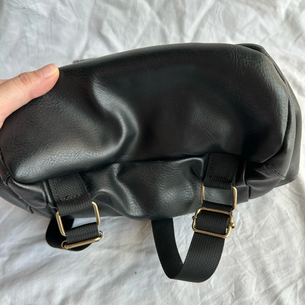 Black Faux Leather Drawstring Backpack with Gold Buckle Accent